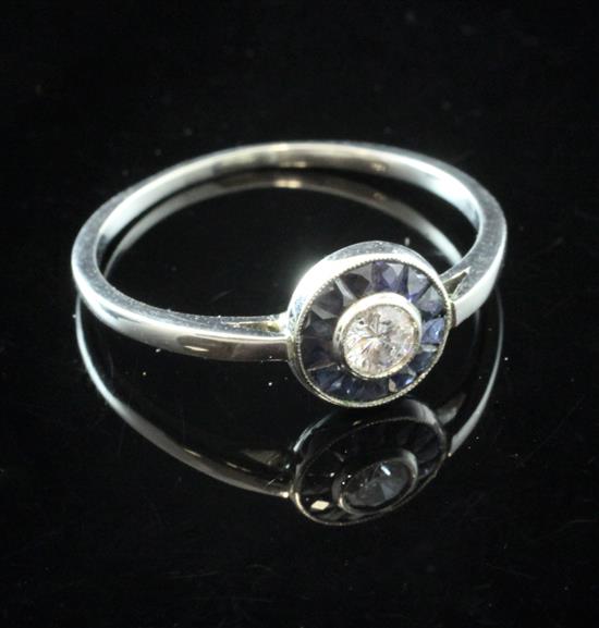 A white gold, sapphire and diamond target ring, size R.